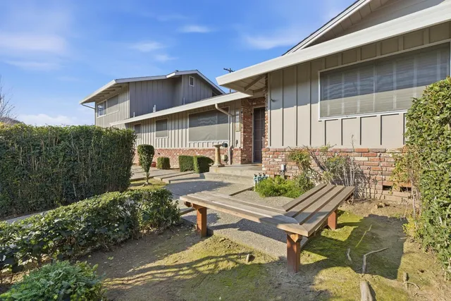 a backyard of a house with table and chairs