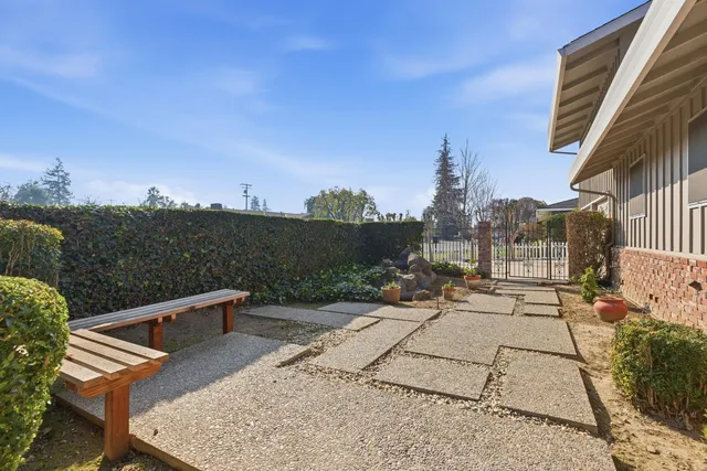 a view of a patio with a table and chairs