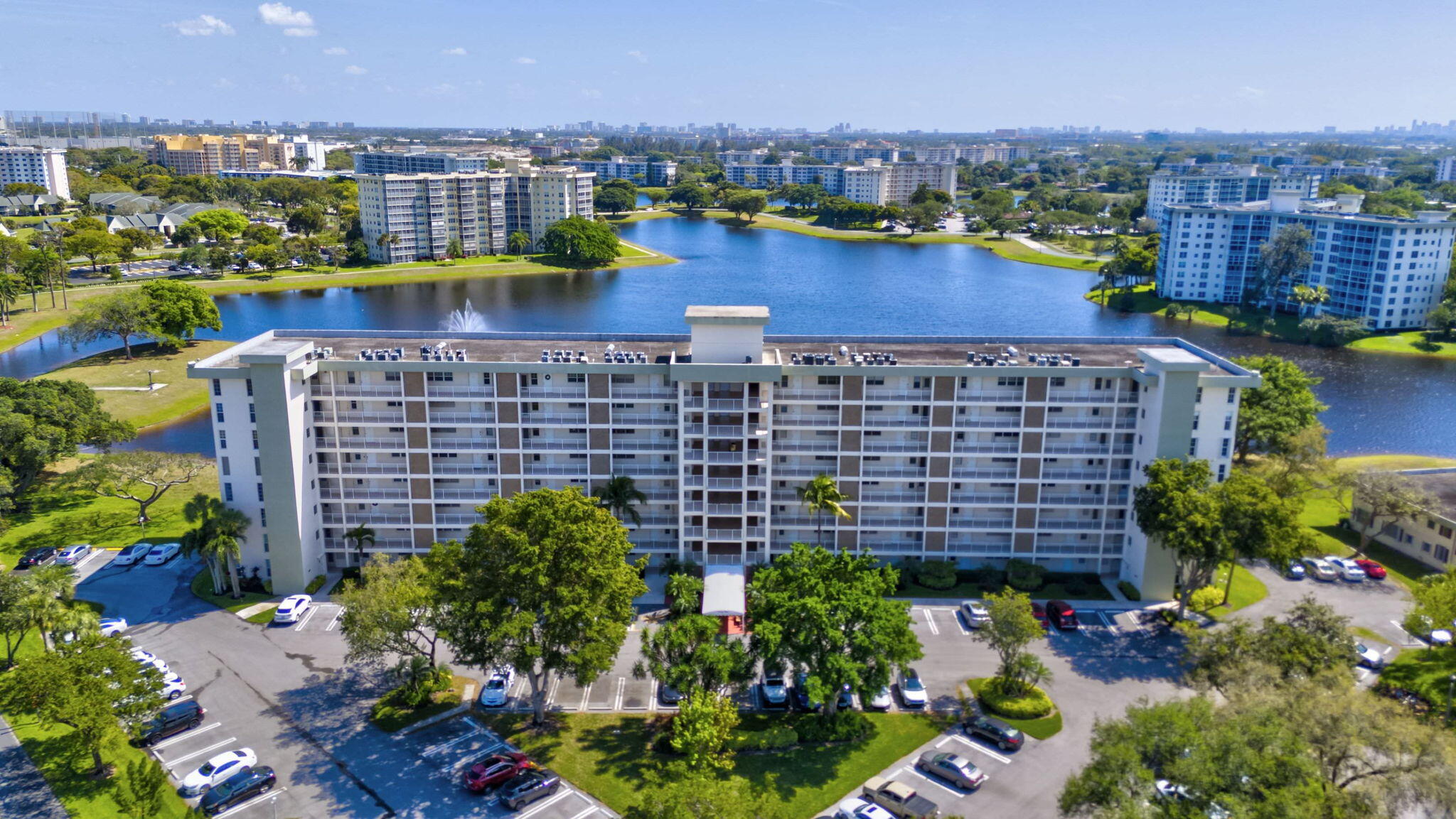 an aerial view of a house with a garden and lake view