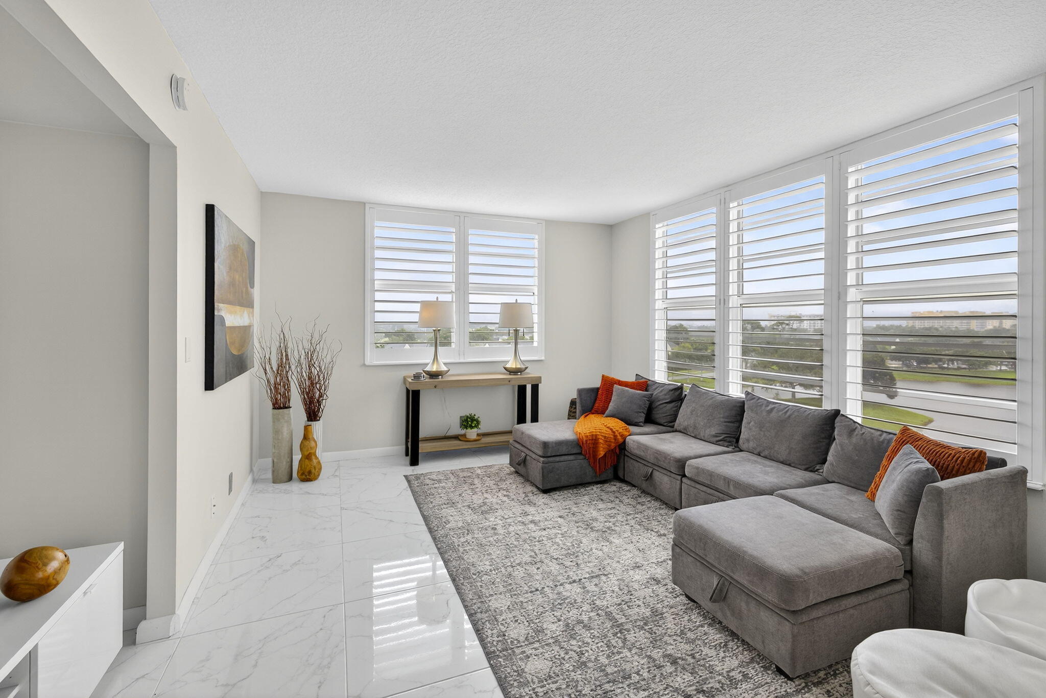 3091 North Course Drive, Unit 710 Pompano Beach, FL 33069 - Photo 13 of 46 a living room with furniture and a large window