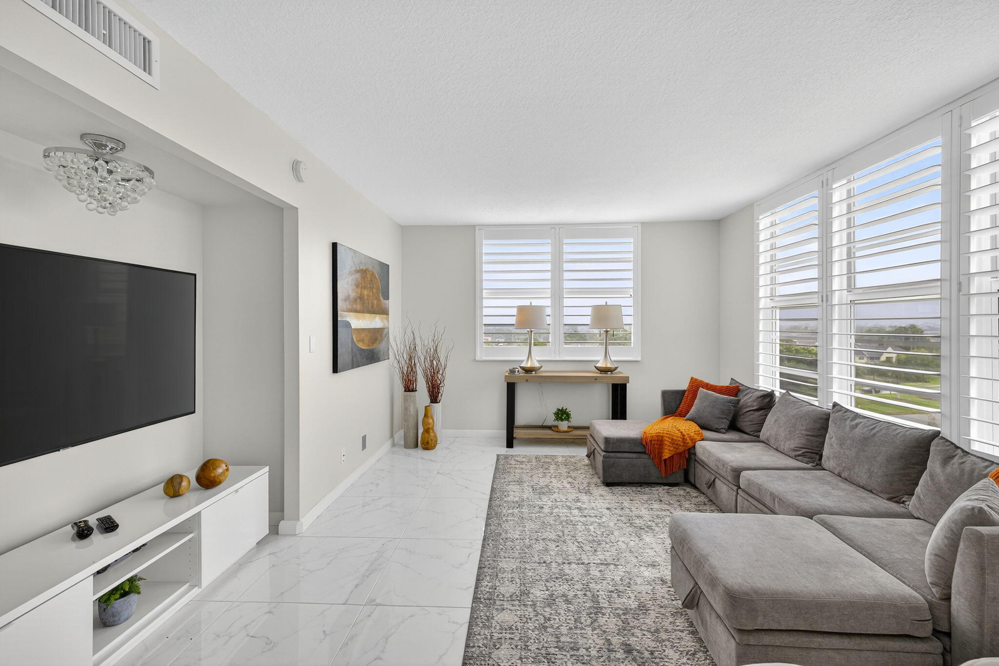 3091 North Course Drive, Unit 710 Pompano Beach, FL 33069 - Photo 14 of 46 a living room with furniture and a flat screen tv