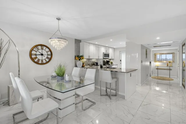 a view of kitchen with kitchen island dining table and stainless steel appliances