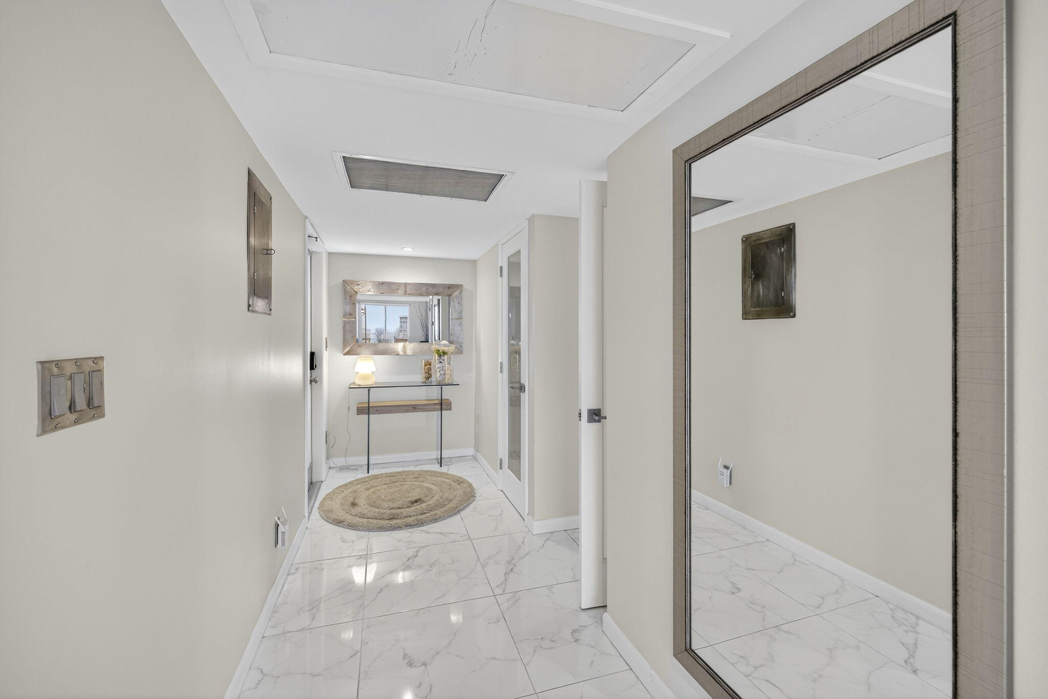 3091 North Course Drive, Unit 710 Pompano Beach, FL 33069 - Photo 20 of 46 a view of a hallway with wooden shelves