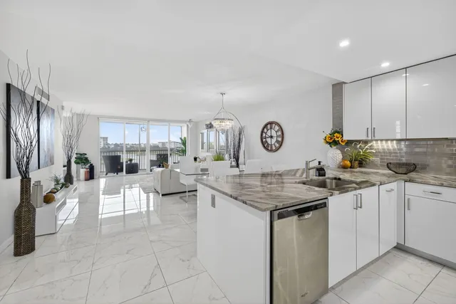 a kitchen with cabinets and chairs