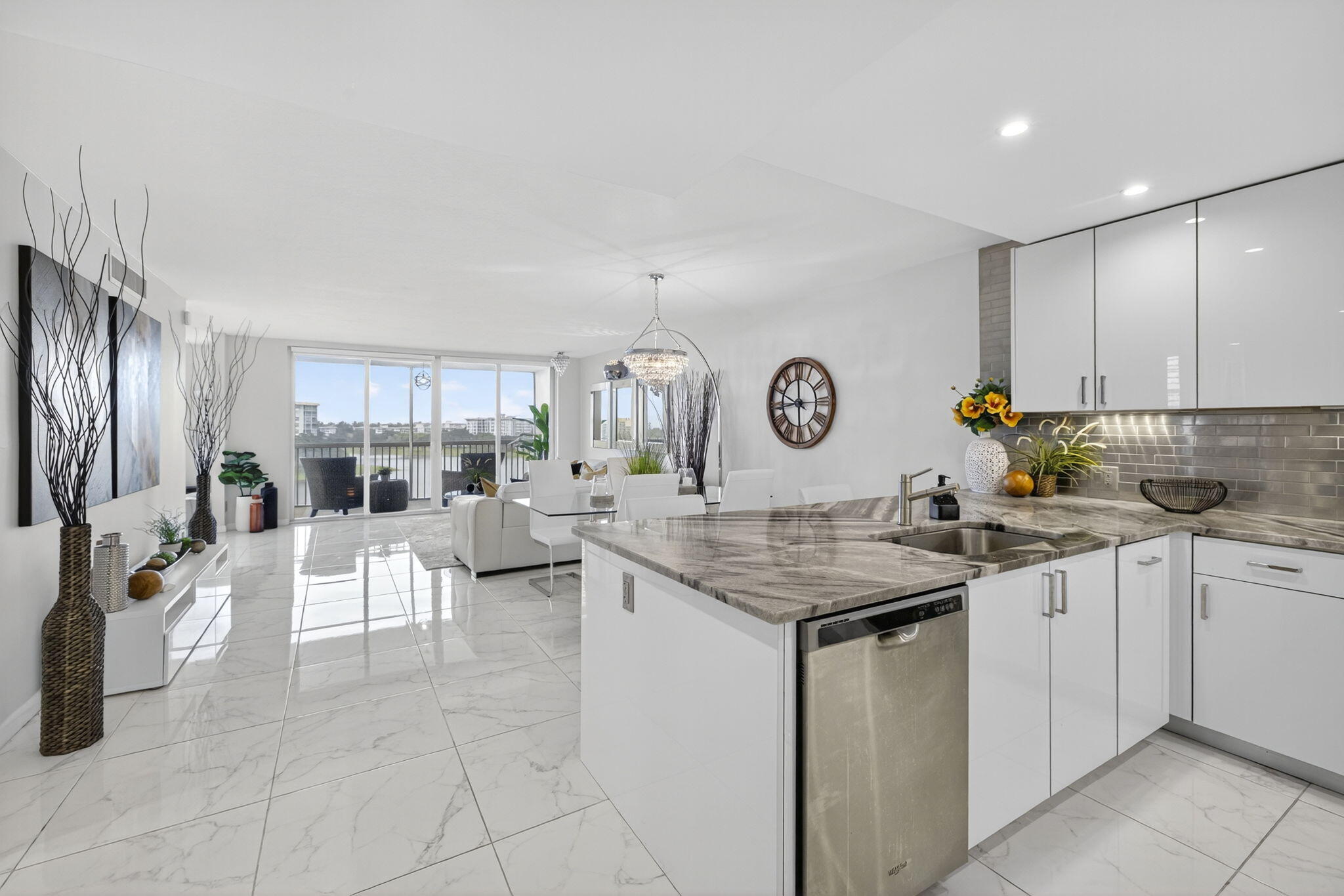 3091 North Course Drive, Unit 710 Pompano Beach, FL 33069 - Photo 2 of 46 a kitchen with cabinets and chairs