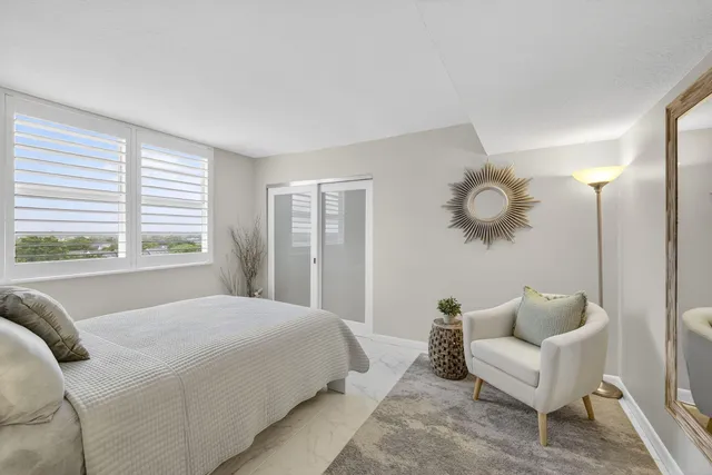 a bedroom with a large bed and a large window