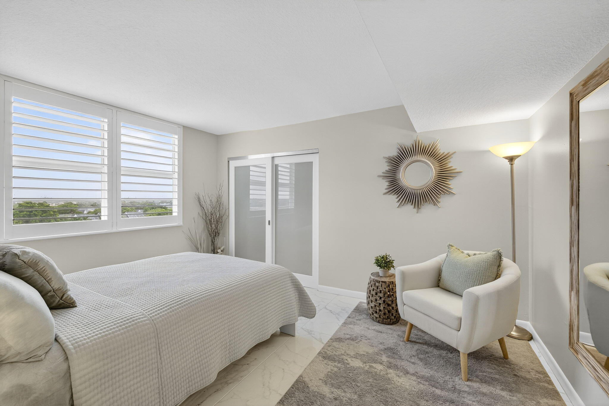 3091 North Course Drive, Unit 710 Pompano Beach, FL 33069 - Photo 22 of 46 a bedroom with a large bed and a large window