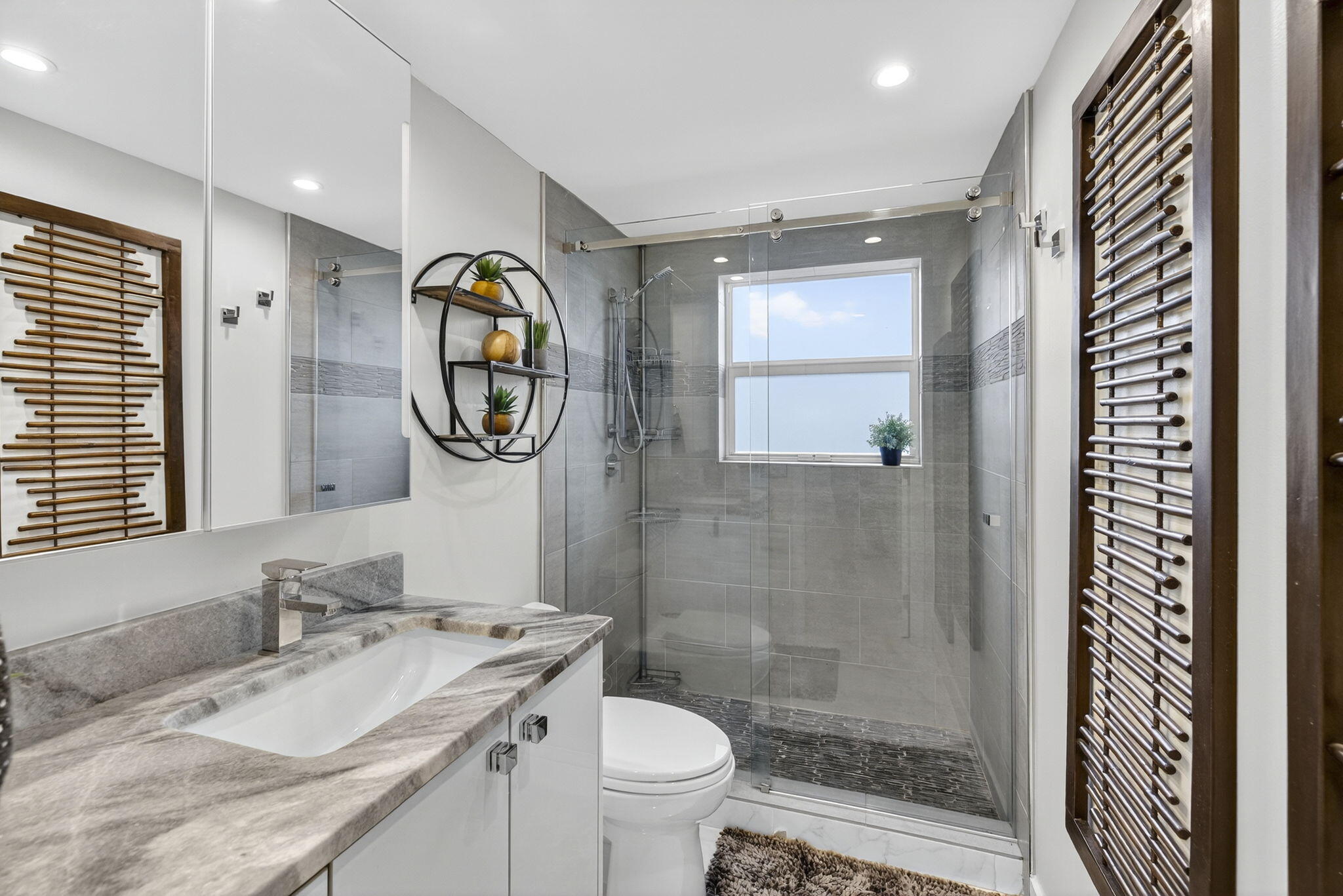 3091 North Course Drive, Unit 710 Pompano Beach, FL 33069 - Photo 23 of 46 a bathroom with a granite countertop toilet a sink and a mirror