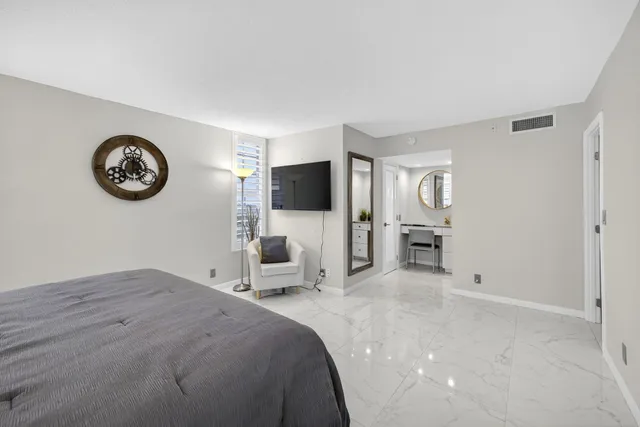 a bedroom with furniture and a large mirror