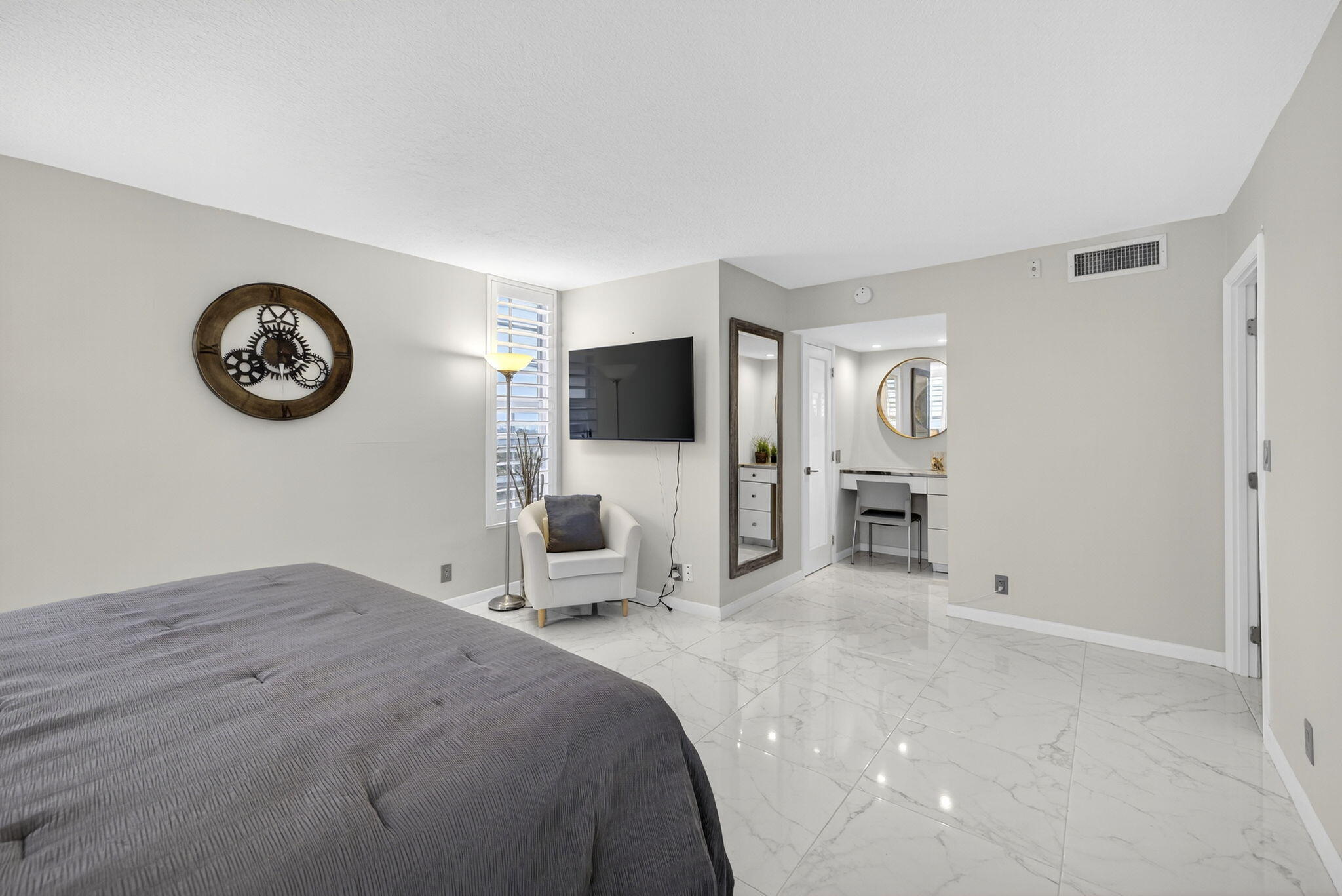 3091 North Course Drive, Unit 710 Pompano Beach, FL 33069 - Photo 28 of 46 a bedroom with furniture and a large mirror