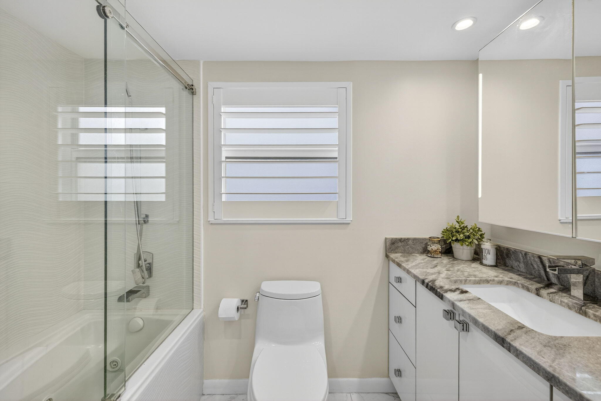 3091 North Course Drive, Unit 710 Pompano Beach, FL 33069 - Photo 31 of 46 a bathroom with a granite countertop sink toilet and shower