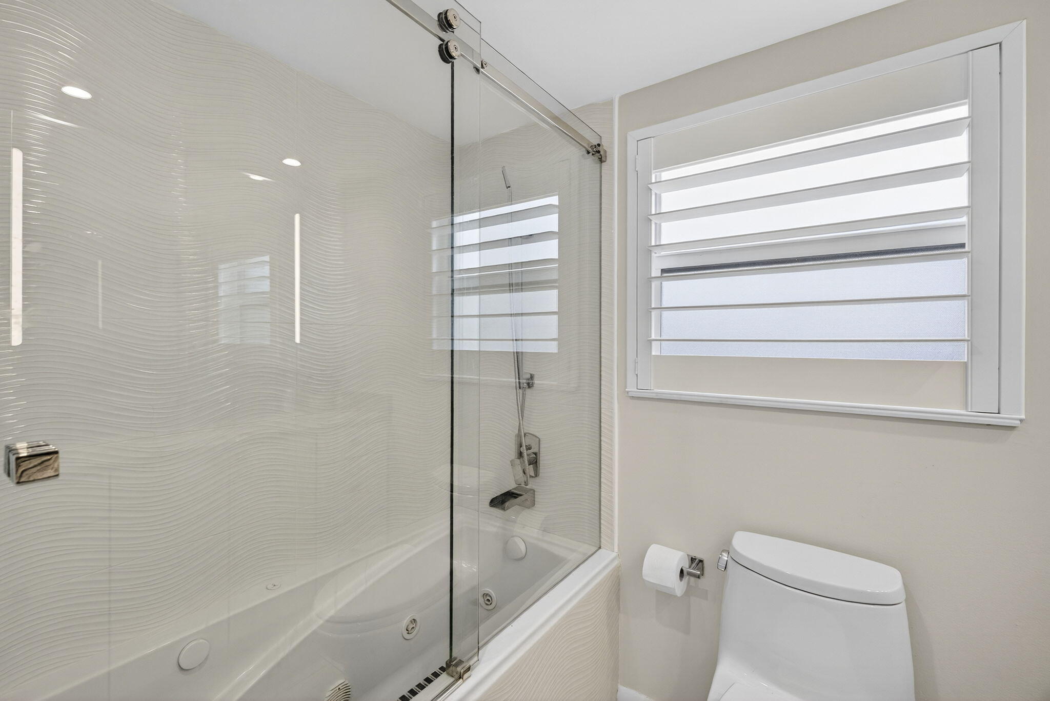 3091 North Course Drive, Unit 710 Pompano Beach, FL 33069 - Photo 32 of 46 a bathroom with a bathtub and a shower