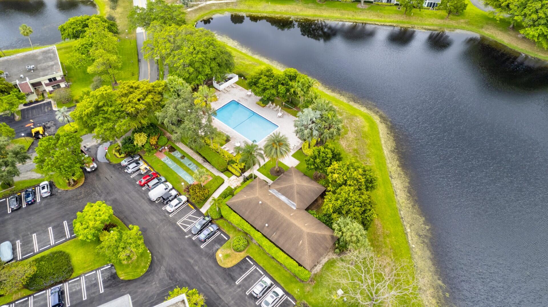 3091 North Course Drive, Unit 710 Pompano Beach, FL 33069 - Photo 44 of 46 a view of swimming pool with a yard