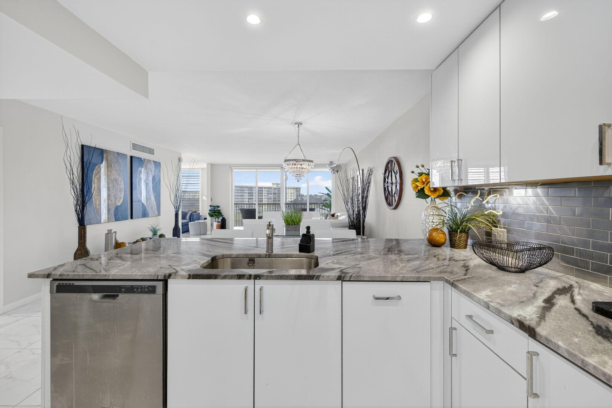 3091 North Course Drive, Unit 710 Pompano Beach, FL 33069 - Photo 5 of 46 a kitchen with sink a counter and cabinets