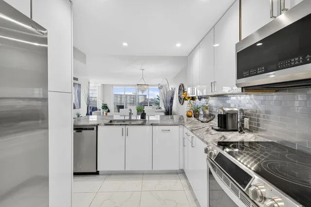 a kitchen with stainless steel appliances granite countertop a sink and a stove