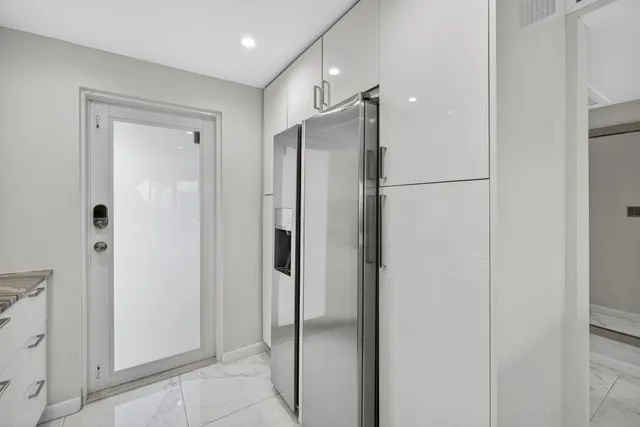 a bathroom with a glass shower door