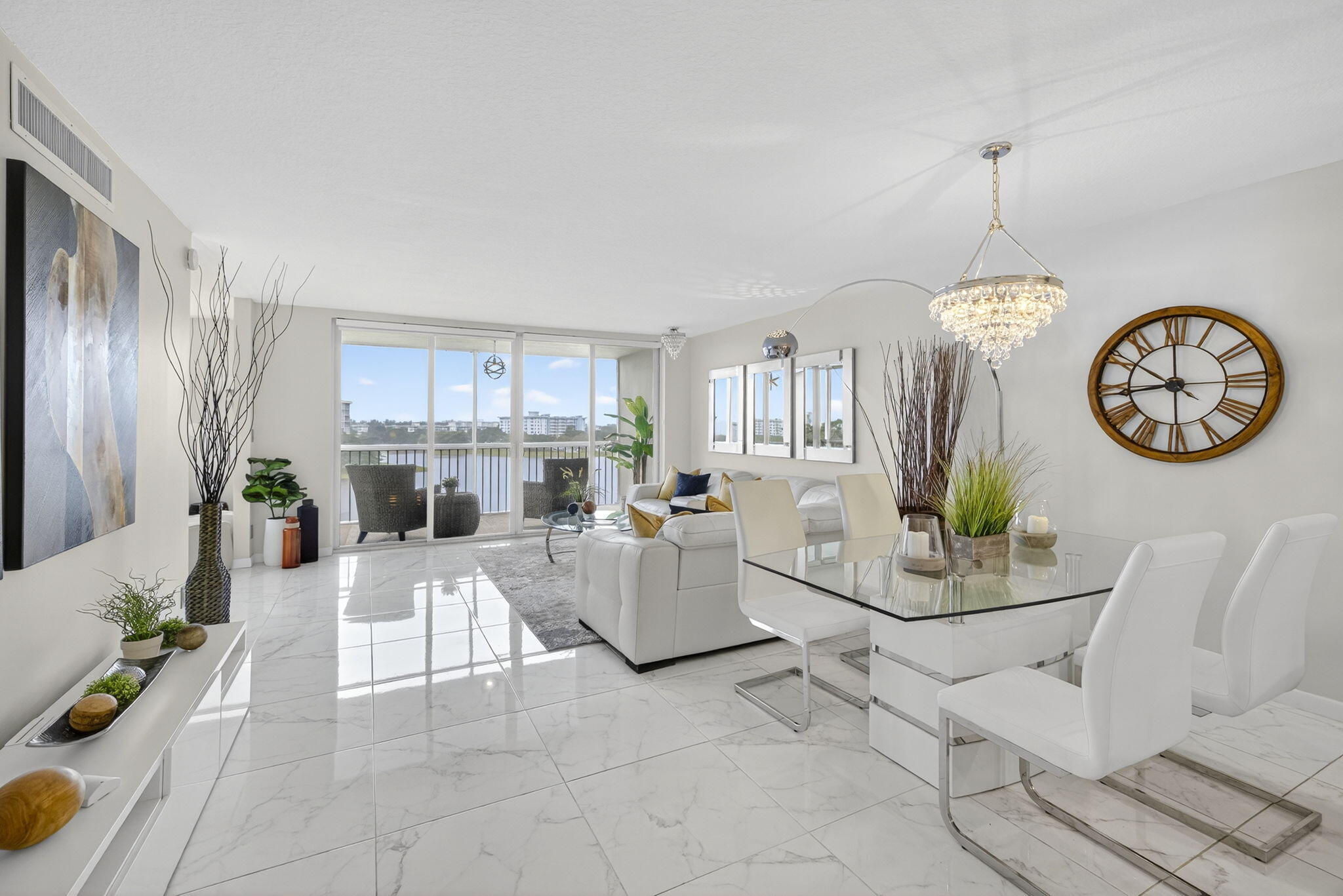 3091 North Course Drive, Unit 710 Pompano Beach, FL 33069 - Photo 9 of 46 a living room with furniture a clock and a view of kitchen