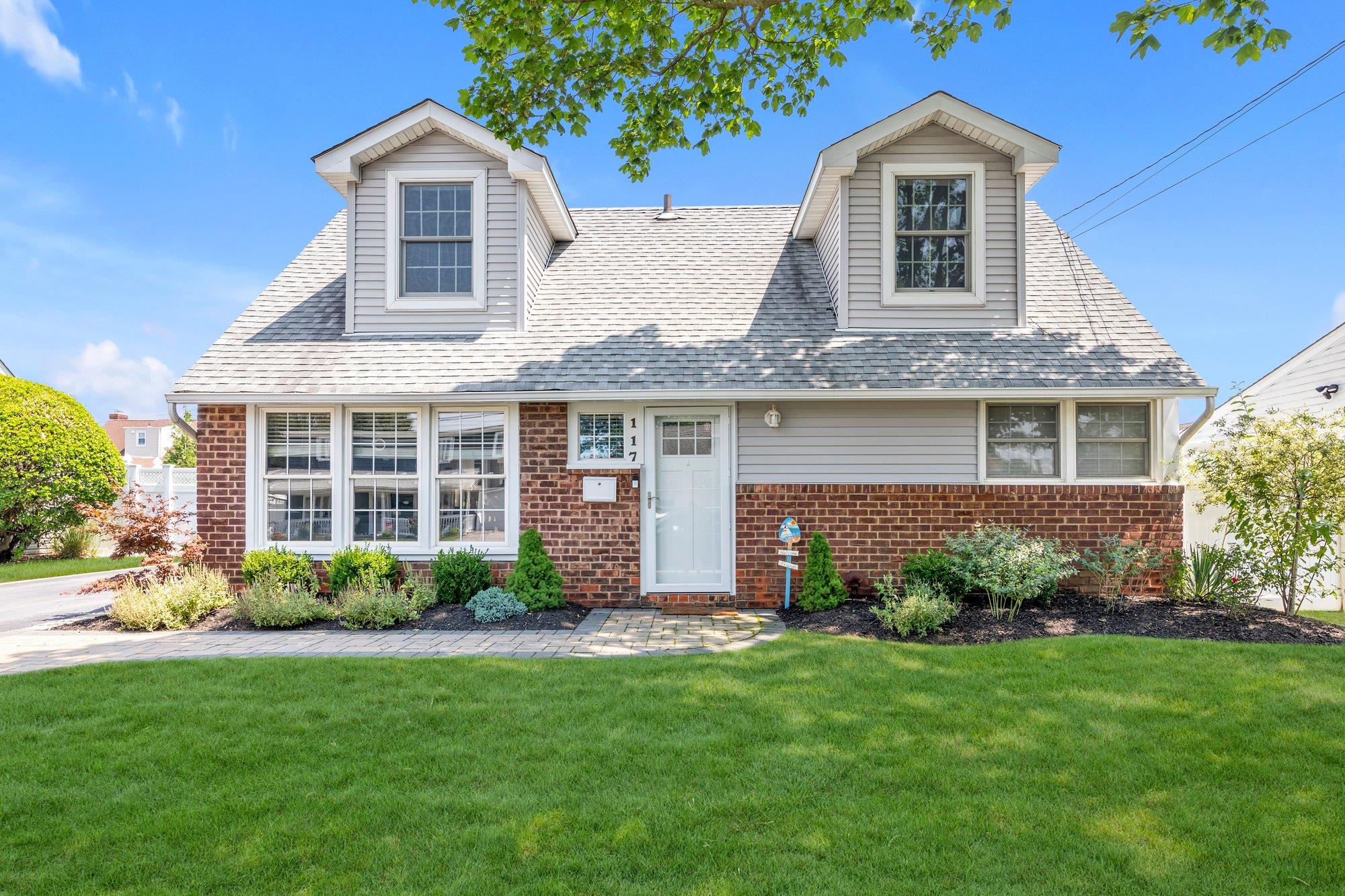 117 Belmill Road Bellmore, NY 11710 - Photo 1 of 1 Cape cod house with brick siding, a front yard, and a shingled roof