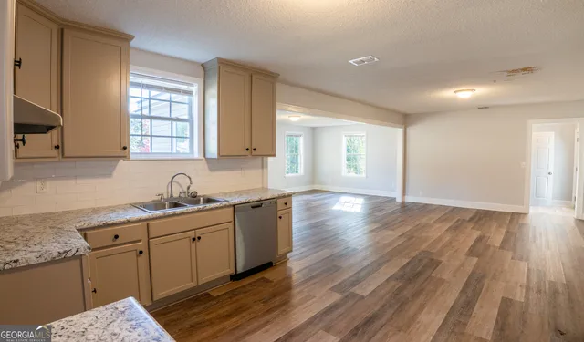 a kitchen with sink and cabinets