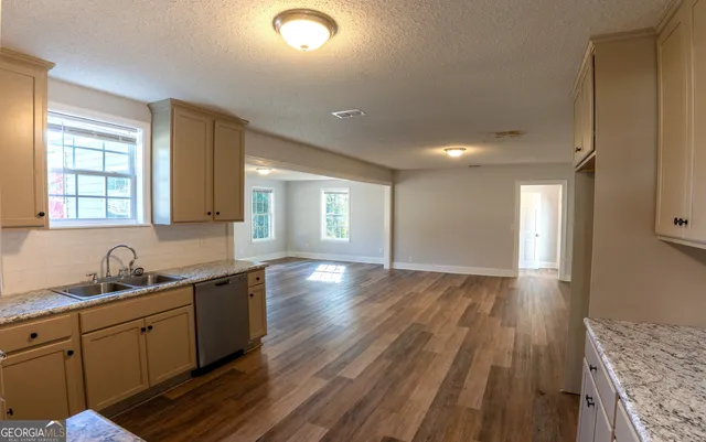 a kitchen with sink and cabinets