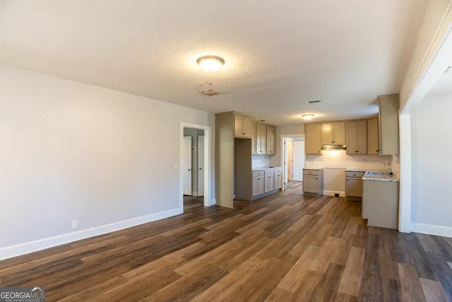 a view of a kitchen with wooden floor