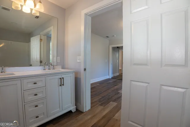 a bathroom with a double vanity sink and mirror