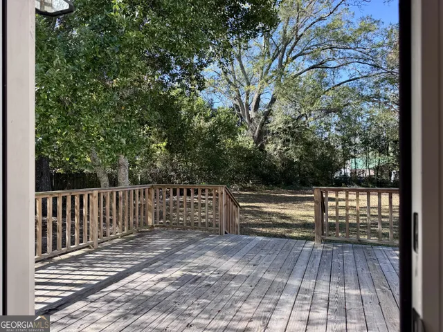 a view of outdoor space with deck and trees