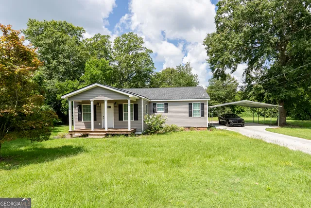 a front view of a house with yard