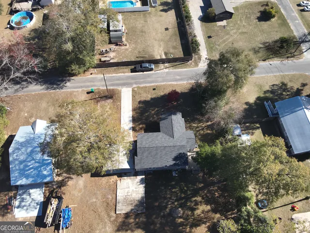 an aerial view of a house with a yard