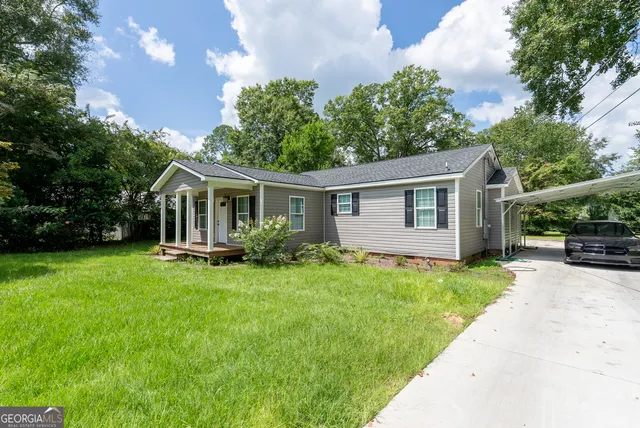 a front view of house with yard and green space