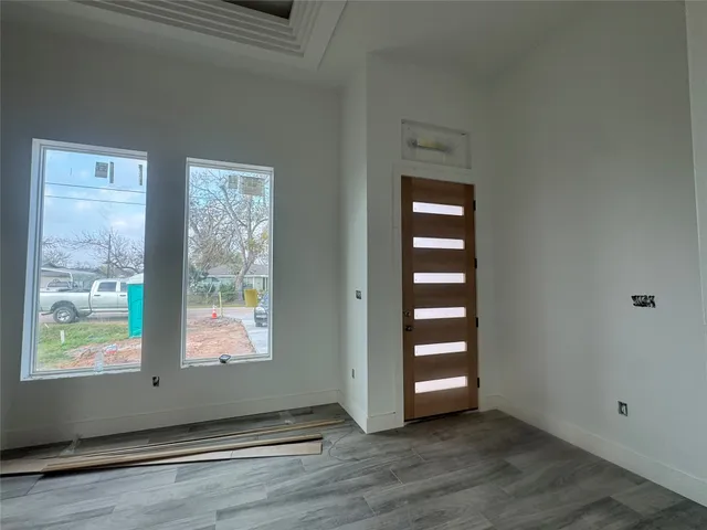 an empty room with windows and closet