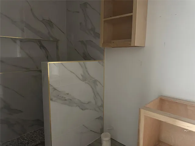 a bathroom with a shower and a sink