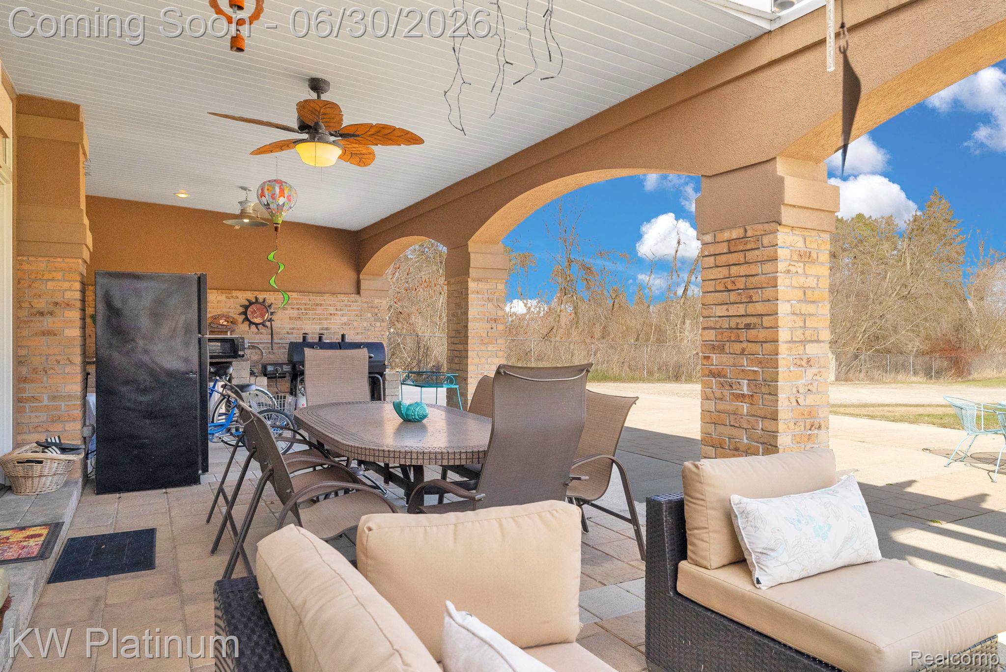 2235 South Lake Shore Road Harbor Beach, MI 48441 - Photo 53 of 99 Covered patio featuring brick columns, arched openings, a ceiling fan, and tile flooring