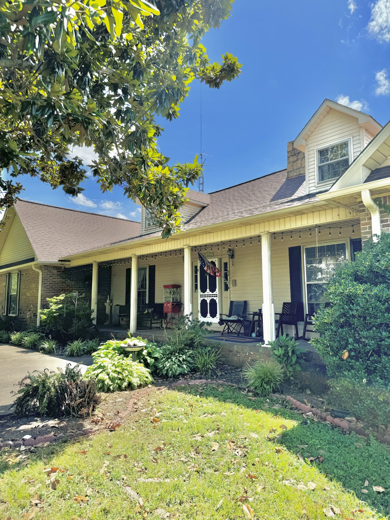 a front view of a house with a yard porch and outdoor seating
