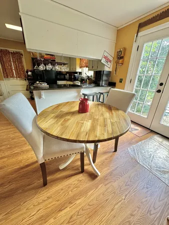 a living room with furniture a rug and a floor to ceiling window