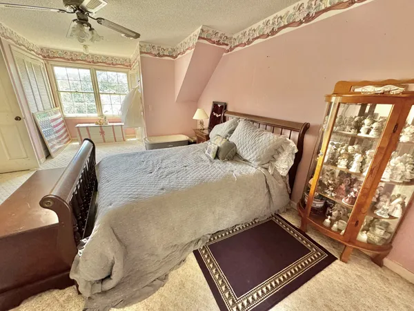 a bed sitting in a bedroom next to a window