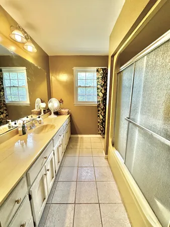 a spacious bathroom with a double vanity sink and a bathtub