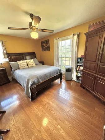 a bedroom with a bed and wooden floor