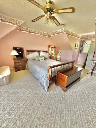 a spacious bedroom with a bed and a table