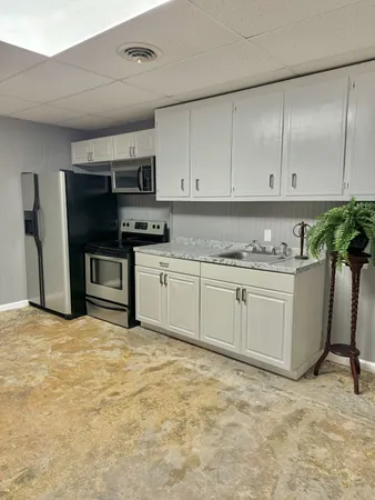 a kitchen with stainless steel appliances granite countertop a stove a sink and a refrigerator