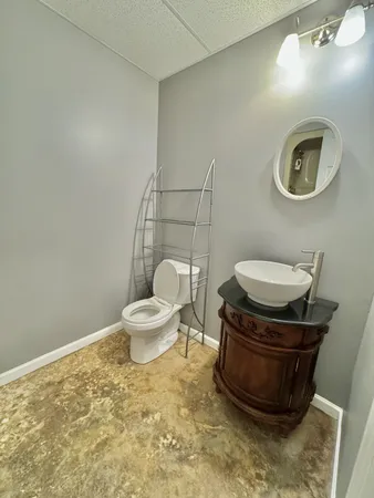 a bathroom with a toilet and a mirror
