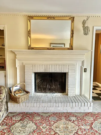 a living room with a fireplace and a rug