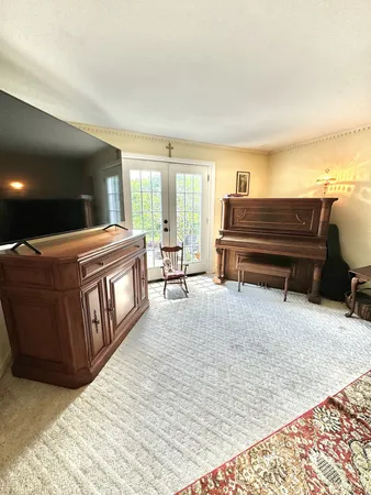 a living room with couch cabinet and a fireplace