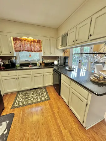 a kitchen with a sink a stove and cabinets
