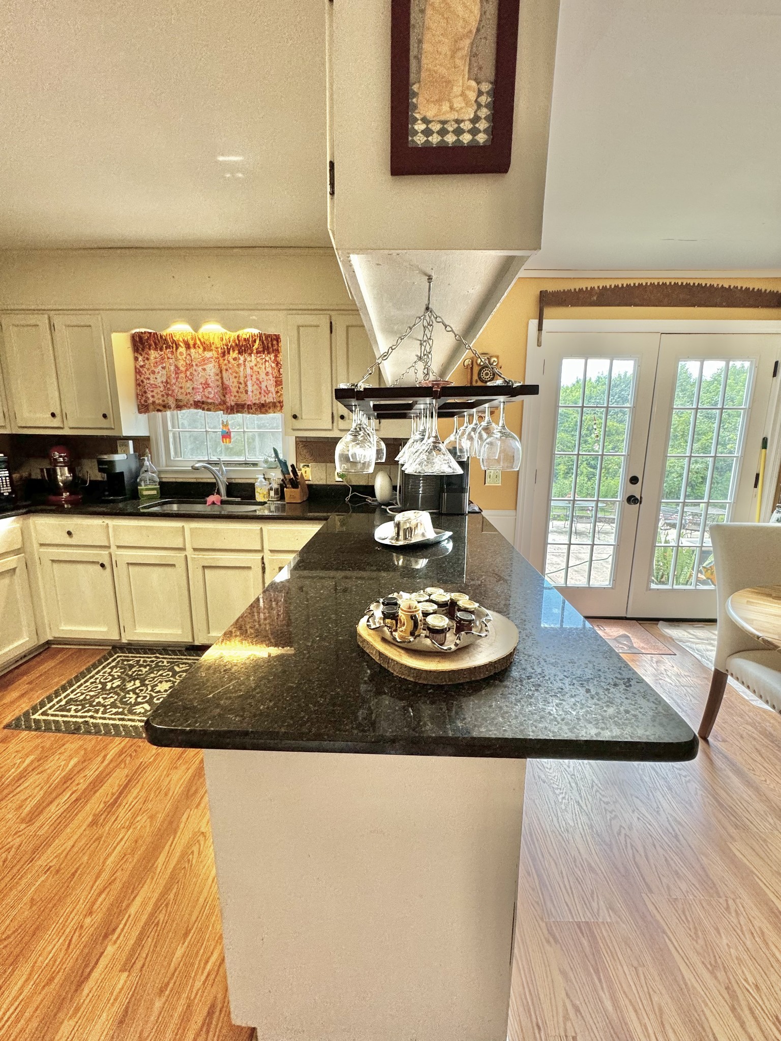 380 Lanning Road Lawrenceburg, TN 38464 - Photo 10 of 54 a kitchen with a stove a sink and a dining table with wooden floor