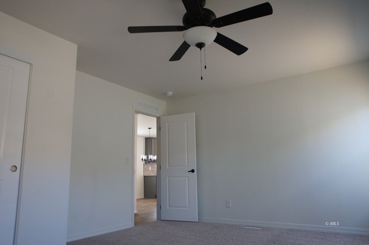 161 Tuolumne Road Bishop, CA 93514 - Photo 13 of 23 en empty room with a ceiling fan and a window