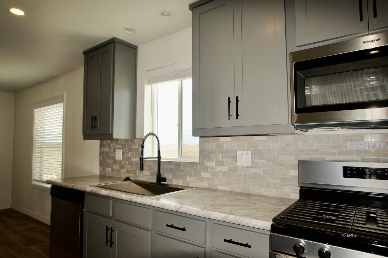 161 Tuolumne Road Bishop, CA 93514 - Photo 2 of 23 a kitchen with stainless steel appliances granite countertop a sink stove and microwave