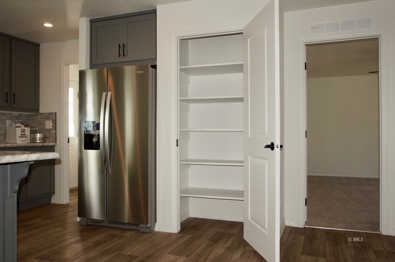 161 Tuolumne Road Bishop, CA 93514 - Photo 3 of 23 a kitchen with a refrigerator and wooden floor