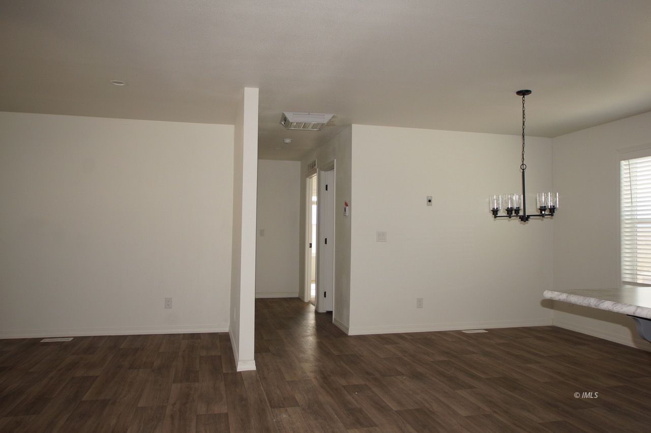 161 Tuolumne Road Bishop, CA 93514 - Photo 4 of 23 a view of an empty room with wooden floor