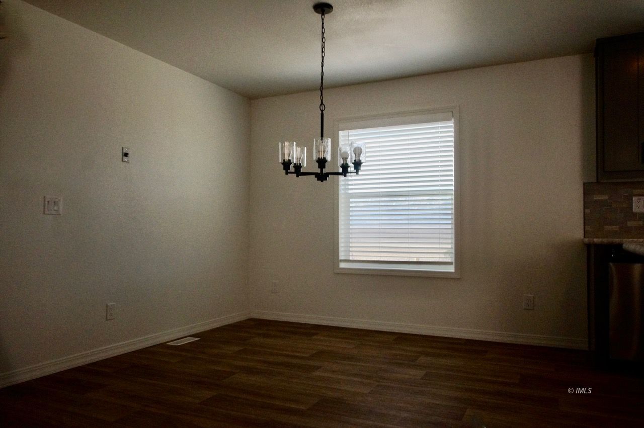 161 Tuolumne Road Bishop, CA 93514 - Photo 5 of 23 a view of a room with wooden floor a ceiling fan and a window